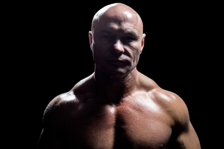 Portrait of on muscular man against black backgroundの写真素材