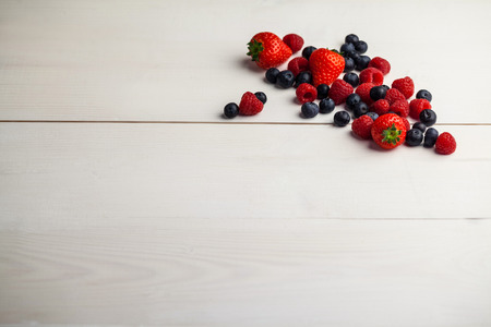 Fresh berries in close up on wooden table