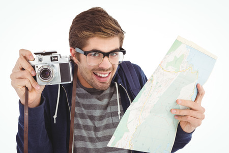 Portrait of happy man holding map and camera against white backgroundの写真素材