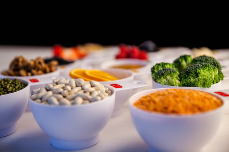 Portion cups of healthy ingredients on wooden tableの写真素材