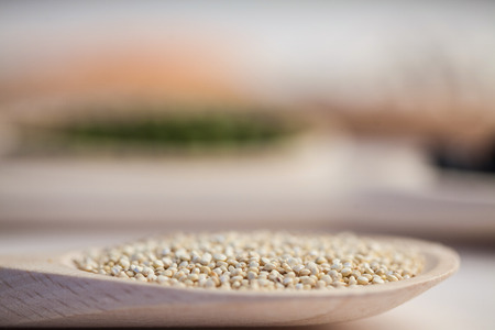 Wooden spoon of sesame seeds on wooden tableの写真素材