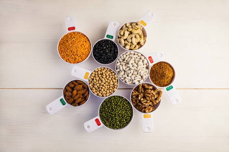 Portion cups of healthy ingredients on wooden tableの写真素材