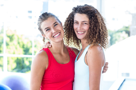 Portrait of women smiling in fitness studioの写真素材