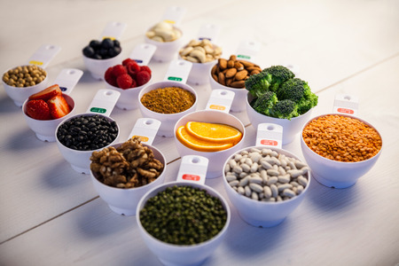 Portion cups of healthy ingredients on wooden tableの写真素材