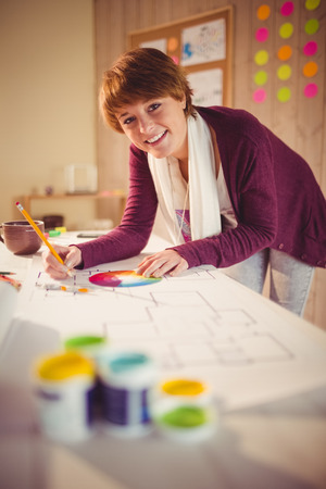 Graphic designer working at desk in officeの写真素材