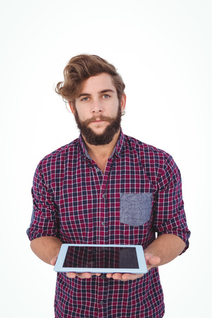 Portrait of hipster holding digital tablet against white backgroundの写真素材
