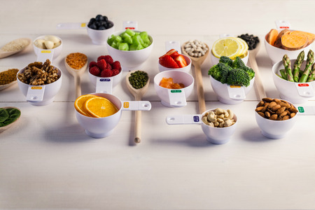 Portion cups of healthy ingredients on wooden tableの写真素材