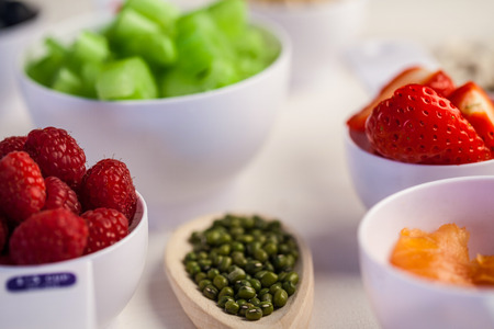 Portion cups of healthy ingredients on wooden tableの写真素材
