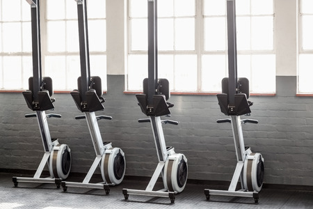Four exercise bikes near each others in crossfit gymの写真素材