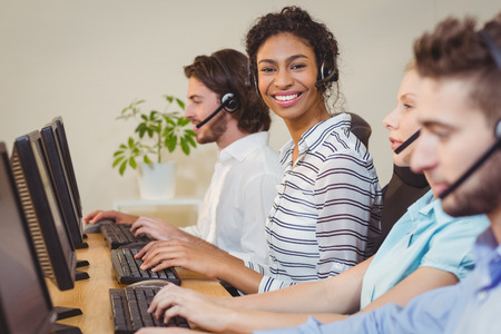 Portrait of smiling businesswoman working in call centerの写真素材