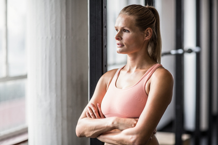 Muscular serious woman thinking in crossfit gymの写真素材