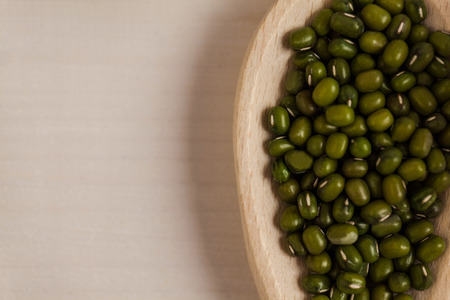 Portion cup of green lentils on wooden tableの写真素材