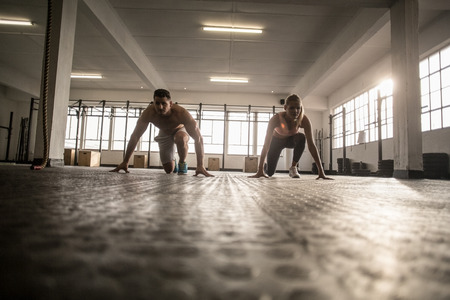 Two fit people doing fitness in crossfit gymの写真素材