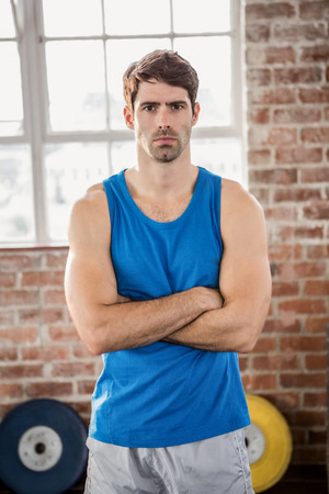 Portrait of muscular man with arms crossed at the gymの写真素材