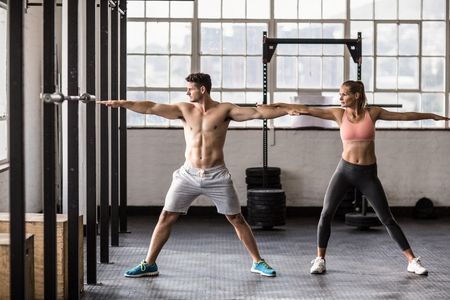 Two fit people doing fitness in crossfit gymの写真素材