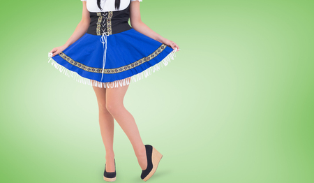 Oktoberfest girl spreading her skirt against green vignetteの写真素材