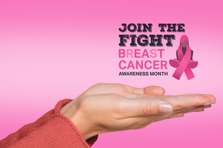 Woman holding out her hands against pinkの写真素材