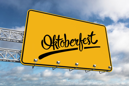 Oktoberfest graphics against blue sky with clouds