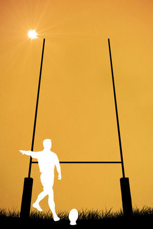 Silhouette of rugby player against orange backgroundの写真素材