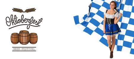 Pretty oktoberfest girl smiling at camera against oktoberfest graphicsの写真素材