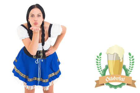 Pretty oktoberfest girl blowing a kiss against oktoberfest graphicsの写真素材