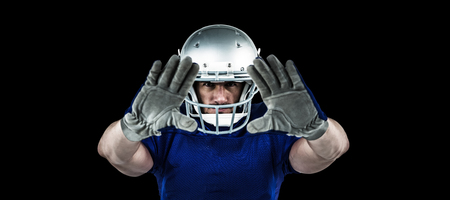 Portrait American football player defending against blackの写真素材