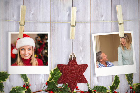 Hanging christmas photos against wooden backgroundの写真素材