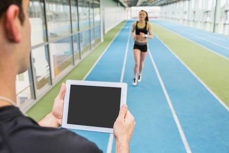 Fit couple on the indoor track at the gymの写真素材