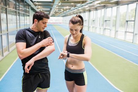 Fit couple on the indoor track at the gymの写真素材