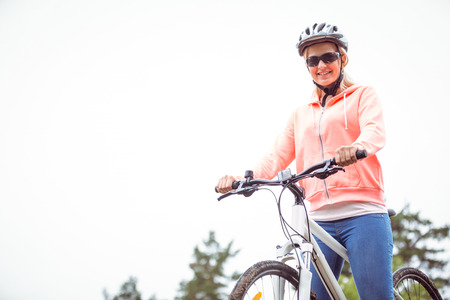 Happy woman on a bike ride in the countrysideの写真素材