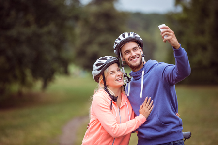 Happy couple on a bike ride in the countrysideの写真素材