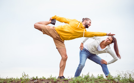 Couple stretching on a hike in the countrysideの写真素材