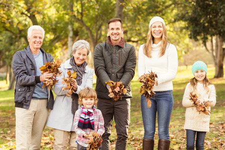 Extended family are ready to throw leaves around on an autumns day