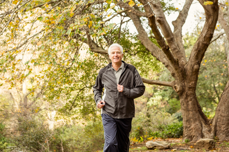 Senior man working out in park on an autumns dayの写真素材