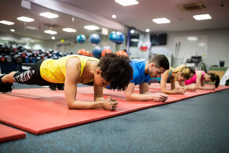 Fit people working out in fitness class at the gym