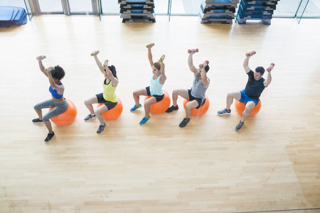 Fitness class exercising in the studio at the gym