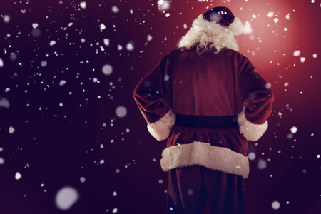 Rear view of father christmas against snowの写真素材