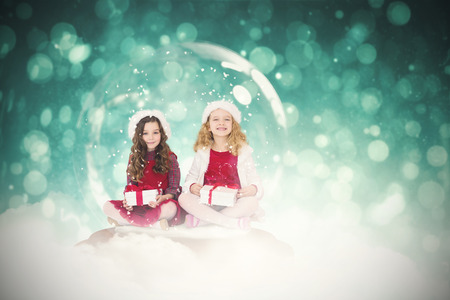 Festive child in snow globe against blue abstract light spot design