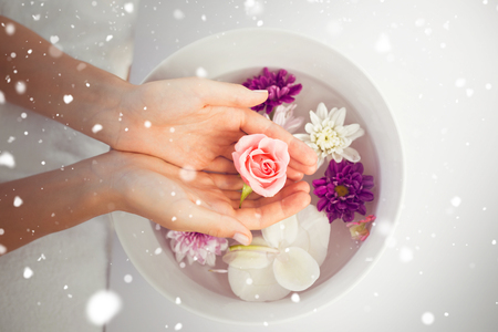 Snow against  petals of flower in wooden bowlの写真素材