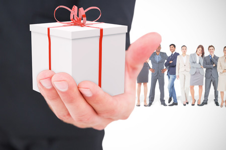 Businessman holding out his hand against red and white presentの写真素材