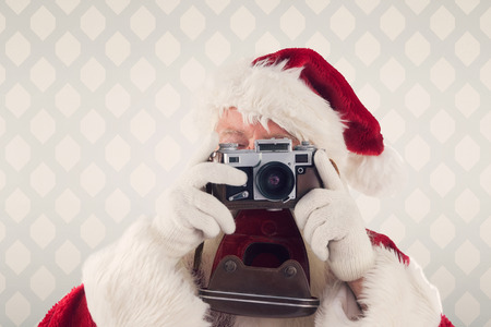 Santa is taking a picture against room with wooden floorの写真素材