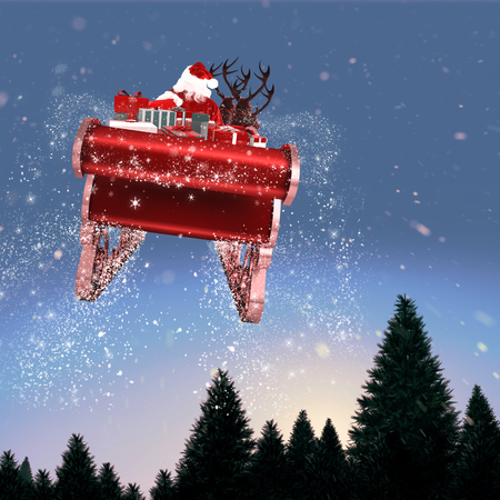 Santa flying his sleigh against snow falling on fir tree forestの写真素材