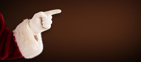 Santa Claus points at something against white background with vignetteの写真素材