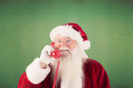 Santa claus on the phone against room with wooden floorの写真素材