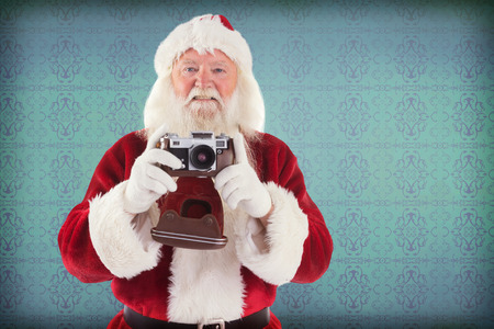 Santa is taking a picture against room with wooden floor