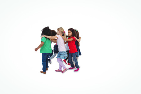 Smiling girls all holding each others shoulders against a white backgroundの写真素材