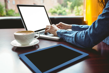 Student using laptop in cafe at the university