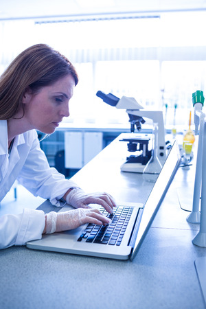 Scientist working with a laptop in laboratory at the universityの写真素材