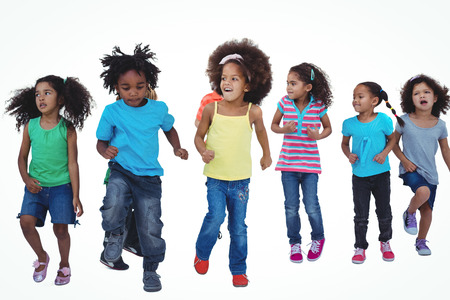 A row of children standing together against a white backgroundの写真素材