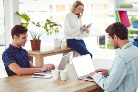 Creative businessteam working with computers in casual office